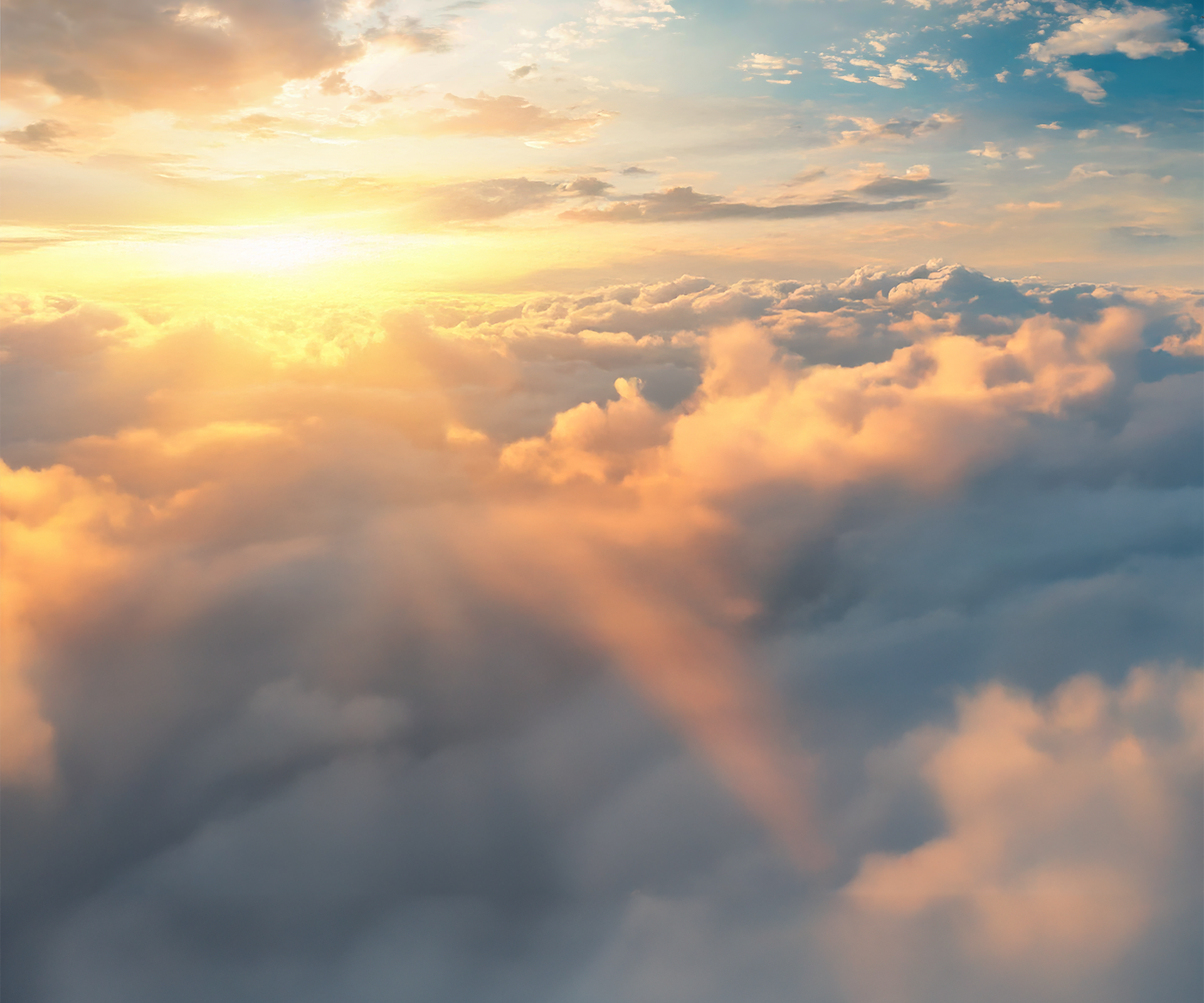 Ein Wolkenmeer am Himmel das durch die Bergspitzen der Alpen bricht.